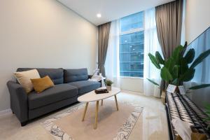 a living room with a couch and a table at Sky Suites KLCC By Calm Sojourn in Kuala Lumpur