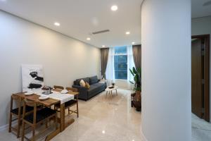 a living room with a table and a couch at Sky Suites KLCC By Calm Sojourn in Kuala Lumpur