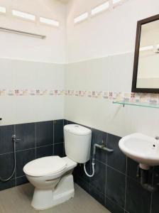 a bathroom with a toilet and a sink at Kurau Stone Chalet in Taiping