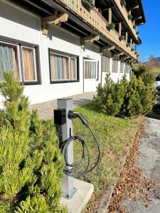 a gas pump in front of a building with christmas trees at Hotel Regina Delle Dolomiti in Panchia