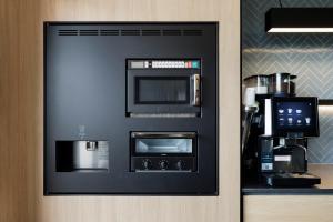 a black vending machine in a hotel room at Fairfield by Marriott Saga Ureshino Onsen in Ureshino