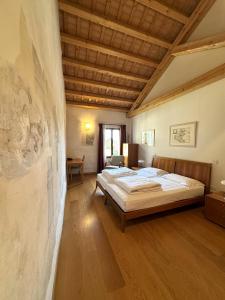 a bedroom with two beds and a wall at Campus San Francesco in Conegliano