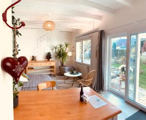 a living room with a table and chairs and a room with a window at Gîte Mozart - Marché de Noël in Colmar +14 photos