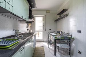 a kitchen with a sink and a table with chairs at Green house in Monopoli