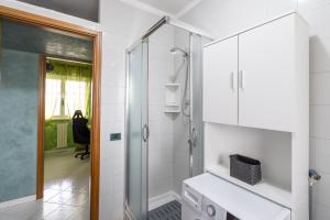 a bathroom with a shower and a glass door at Green house in Monopoli