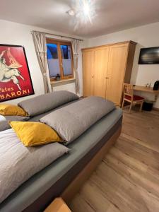 a large bed in a bedroom with a desk at Landhaus Alpenland in Zug