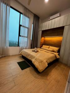 a bedroom with a large bed with a large window at ITCC Manhattan Suites by Blossom37 in Donggongon