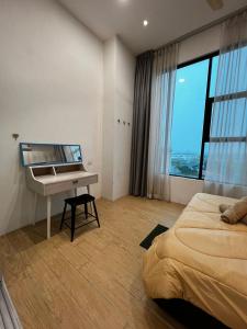 a bedroom with a bed and a desk and a piano at ITCC Manhattan Suites by Blossom37 in Donggongon