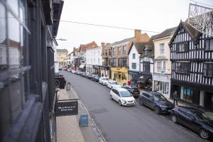 a city street with cars parked on the street at The Penthouse at Mercers Croft in Stratford-upon-Avon