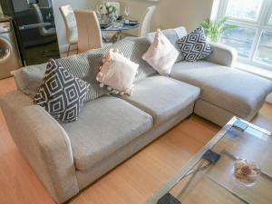 a living room with a couch with pillows on it at Pass the Keys Super luxurious 2 bedroom apartment in Nottingham