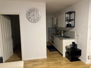 a kitchen with a clock on the wall at Urlaub in Schlossnähe in Artstetten