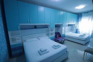 a room with two beds and blue cabinets at Marco Aurelio in Rome