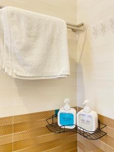 - une salle de bains avec 2 conteneurs de savon sur un portant dans l'établissement Hotel Aloha 2, à Ninh Hải