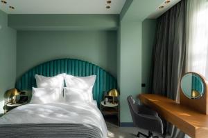 um quarto com uma cama grande e uma cabeceira azul em Khedi Hotel by Ginza Project em Tbilisi