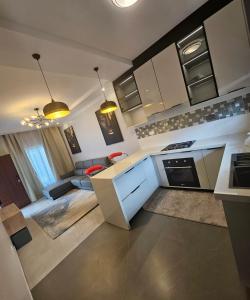 a kitchen with white cabinets and a living room at Vk apartments in Kitwe