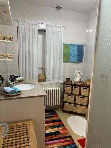 a bathroom with two sinks and a radiator at Chez Patrice et Marieline in Usson-en-Forez