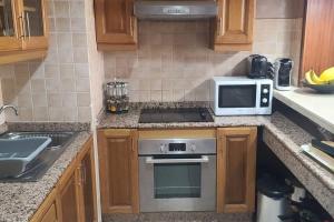 a kitchen with a stove and a microwave at Agadir Marina in Agadir