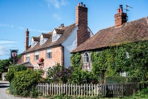 an old house with ivy growing on it at The Red Lion in East Bergholt