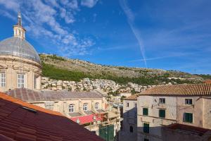a view of a city with a hill in the background at Dominium Premium Location Suites in Dubrovnik
