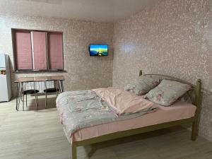 a bedroom with a bed and a table in it at Днестровский in Kharkiv