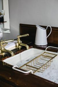 a sink with a white pitcher sitting next to it at Ballyvolane House in Fermoy