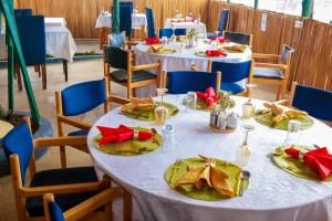 a group of tables with red and green napkins at Amanya 1-Bed Leopard Family with Mt Kilimanjaro vi in Amboseli