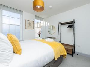 a bedroom with a large bed with a yellow blanket at Pass the Keys Stunning 2 bed retreat in the heart of Bath in Bath