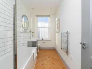 a white bathroom with a tub and a sink at Pass the Keys Stunning 2 bed retreat in the heart of Bath in Bath