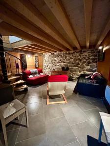 a large living room with a stone wall at Chalet La Léchère in Valmeinier