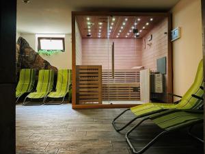 a group of green chairs in a waiting room at Hotel Pruggererhof in Pruggern