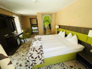 a bedroom with a bed and a desk in a room at Hotel Pruggererhof in Pruggern +30 photos