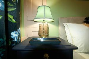 a table with a lamp on top of a bed at Bridge Street Rows City Centre Apartment by Rework Accommodation in Chester