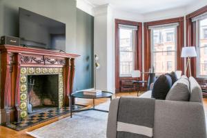 a living room with a fireplace and a tv at Boston Studio on Newbury w A shopping dining BOS-600 in Boston