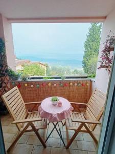 a table and two chairs on a balcony at Noel's Room in Fiesole