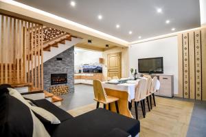 a dining room with a table and a fireplace at Magiczny Domek in Białka Tatrzanska