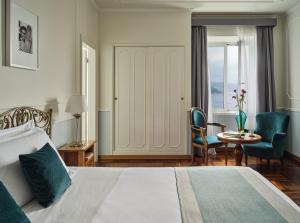 a hotel room with a bed and a table and chairs at Grand Hotel Miramare in Santa Margherita Ligure