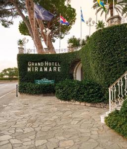 a sign for the grand hotel miramar with flags at Grand Hotel Miramare in Santa Margherita Ligure