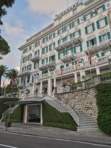 a large white building with stairs in front of it at Grand Hotel Miramare in Santa Margherita Ligure