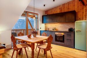 a kitchen with a wooden table and a refrigerator at Rotwandterhof Wohnung Bienenstock in Barbiano +22 photos
