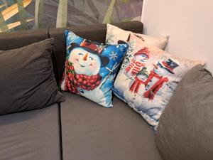 a couch with two christmas pillows on it at Brzozowy Zakątek in Bochnia