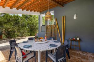 a dining table and chairs in a patio with a table and chairsktop at Villa Amoreira by Villa Plus in Lagoa
