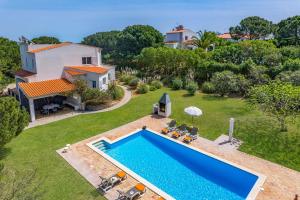 an aerial view of a villa with a swimming pool at Villa Amoreira by Villa Plus in Lagoa