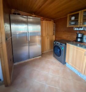 a kitchen with a refrigerator and a washing machine at Appart bien équipé avec jardin privé à California in Casablanca