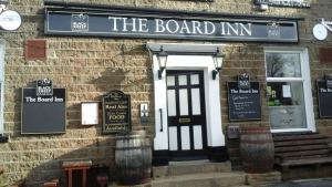 a building with a sign for the board inn at The Board Inn in Hawes
