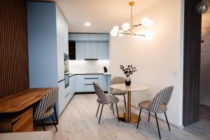 a kitchen and dining room with a table and chairs at AH Albelli II in Košice +10 photos
