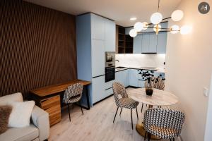 a kitchen and living room with a table and chairs at AH Albelli II in Košice
