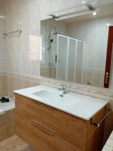 a bathroom with a sink and a mirror at Cal Robert in Tremp