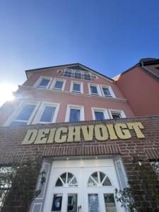 a building with a sign that reads december wolf at Hotel Deichvoigt in Cuxhaven