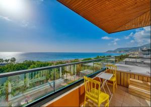 a balcony with chairs and a view of the ocean at Anjeliq Downtown Boutique Hotel in Alanya