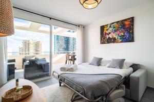 a bedroom with a bed and a large window at Large terrace, sea view, 5mn Monaco, free parking in Beausoleil